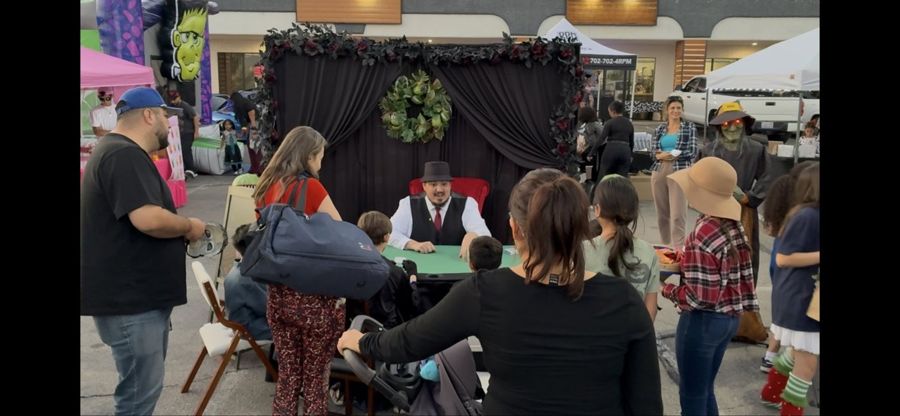 A crowd gathered around The Wizard's reading table